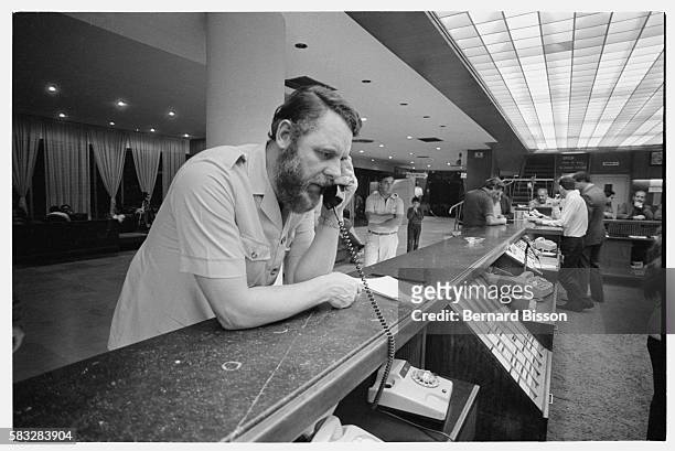 Canterbury's archbishop special hostage negotiator Terry Waite phones from the main desk at the Commodore Hotel.