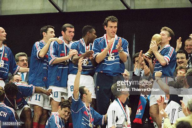 France's captain Didier Deshamps receiving the trophy from the hands of French President Jacques Chirac after France's victory over Brazil in the...