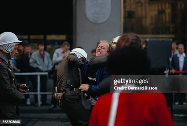 Czechoslovakian police officers arrest a protester in Prague during the celebration of the 70th anniversary of the creation of the Czech state. The...