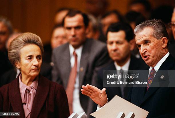 Romanian President Nicolae Ceausescu and wife Elena talk with party members during the closing ceremony of the Romanian Communist Party's 14th...