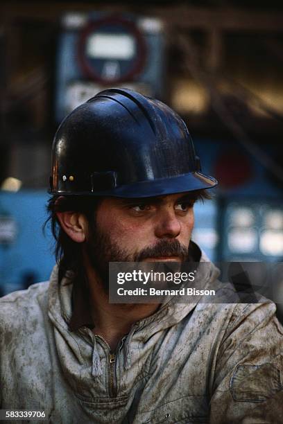 Oil worker wearing a safety helmet. | Location: Tenguiz, Kazakhstan.