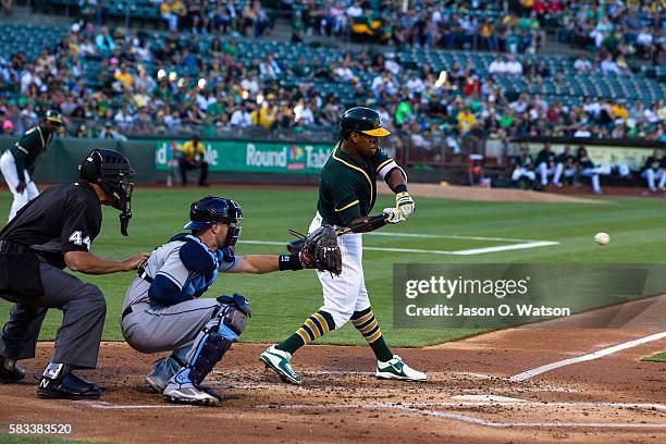 Khris Davis of the Oakland Athletics at bat in front of Curt Casali of the Tampa Bay Rays and umpire Kerwin Danley during the first inning at the...