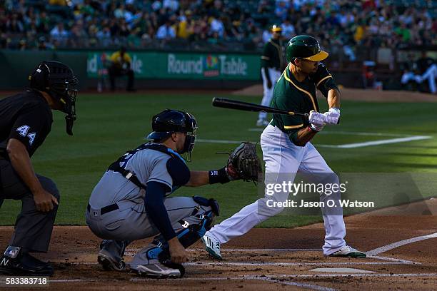 Coco Crisp of the Oakland Athletics at bat in front of Curt Casali of the Tampa Bay Rays and umpire Kerwin Danley during the first inning at the...