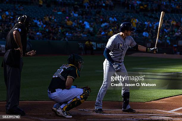 Evan Longoria of the Tampa Bay Rays at bat in front of Matt McBride of the Oakland Athletics and umpire Kerwin Danley during the first inning at the...