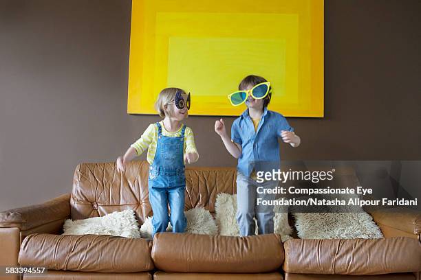 boy and girl wearing oversized sunglasses and mask - sunglasses disguise stock pictures, royalty-free photos & images