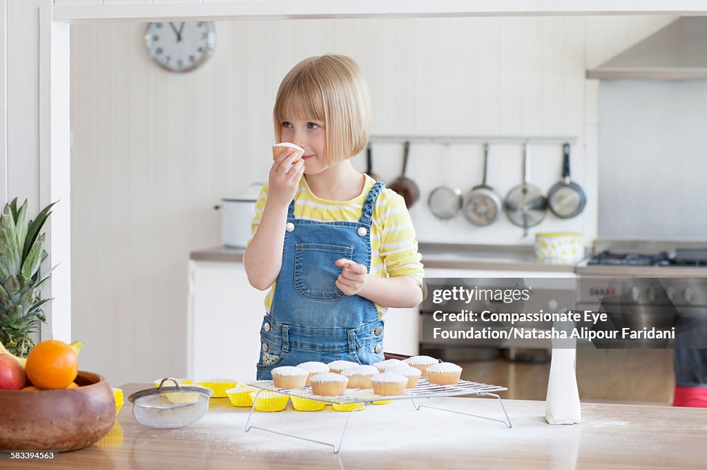 Girl baking cupcakes in kitchen