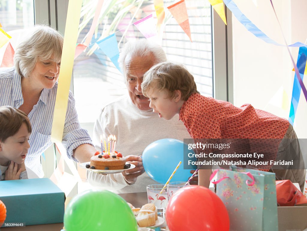 Grandfather celebrating birthday with family