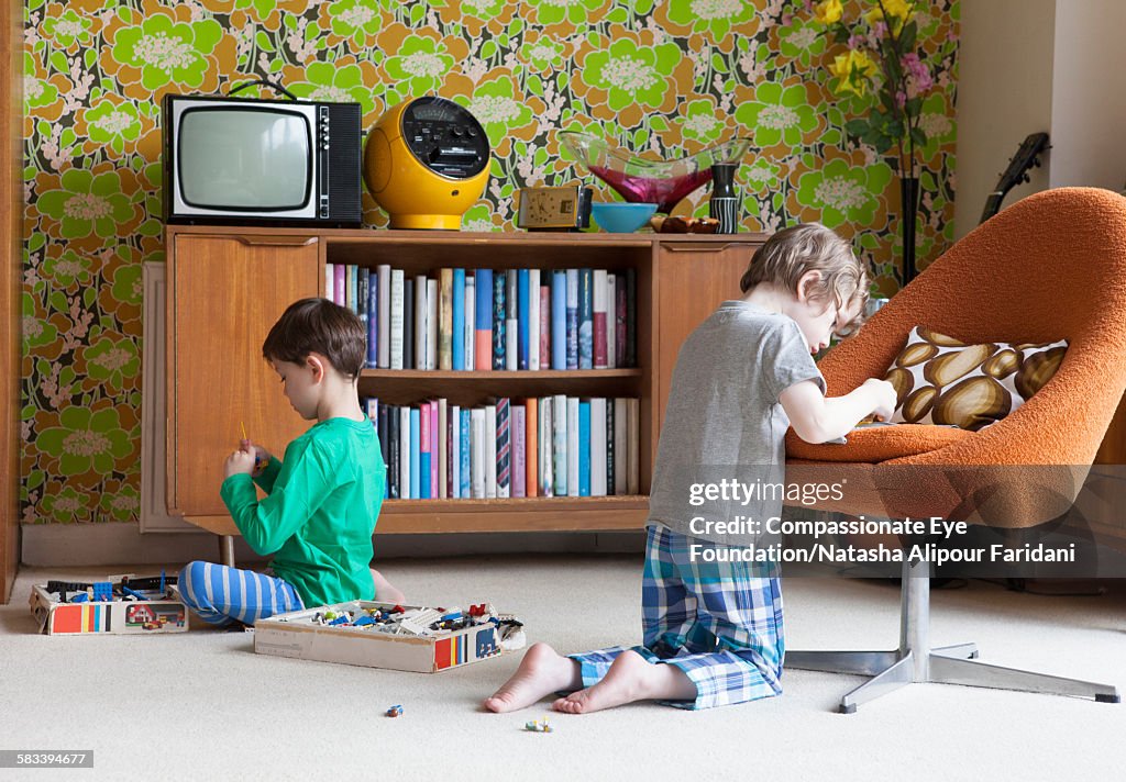 Siblings playing in living room