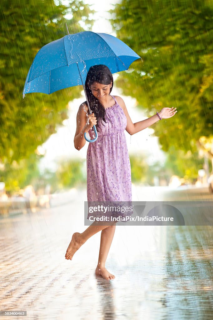 Woman having fun in the rain