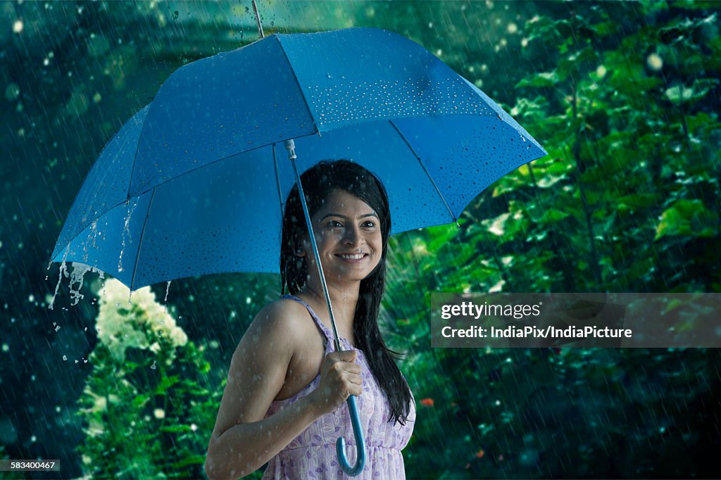 Woman with umbrella smiling