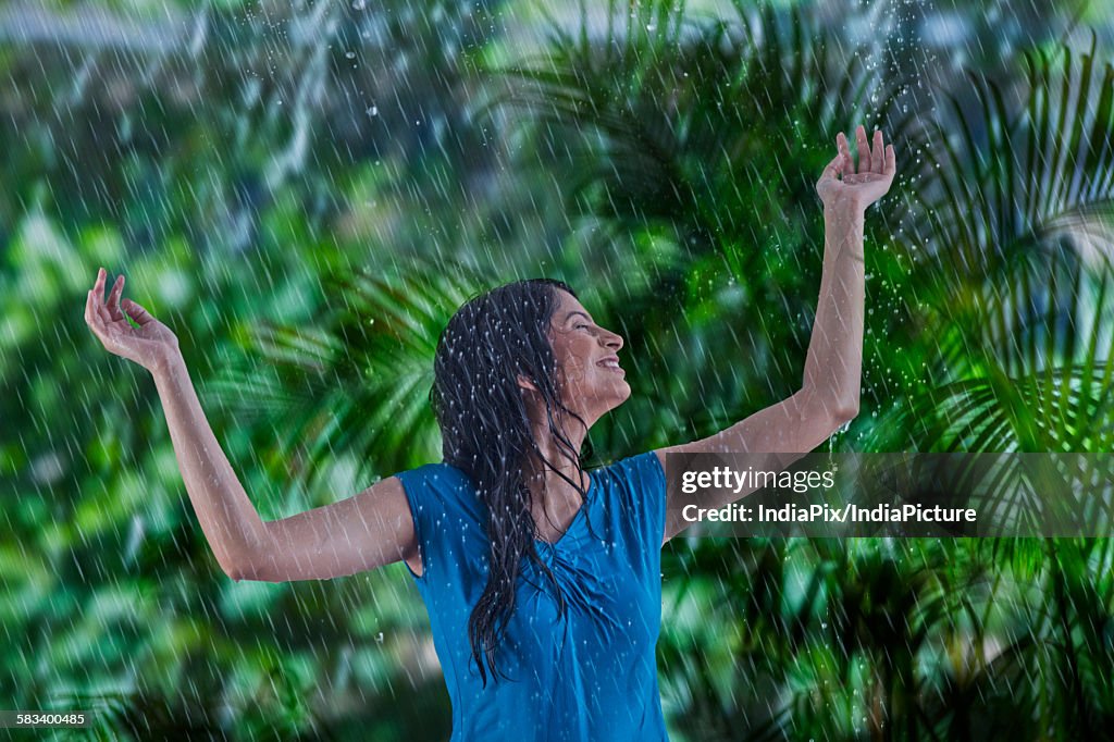 Woman enjoying in the rain