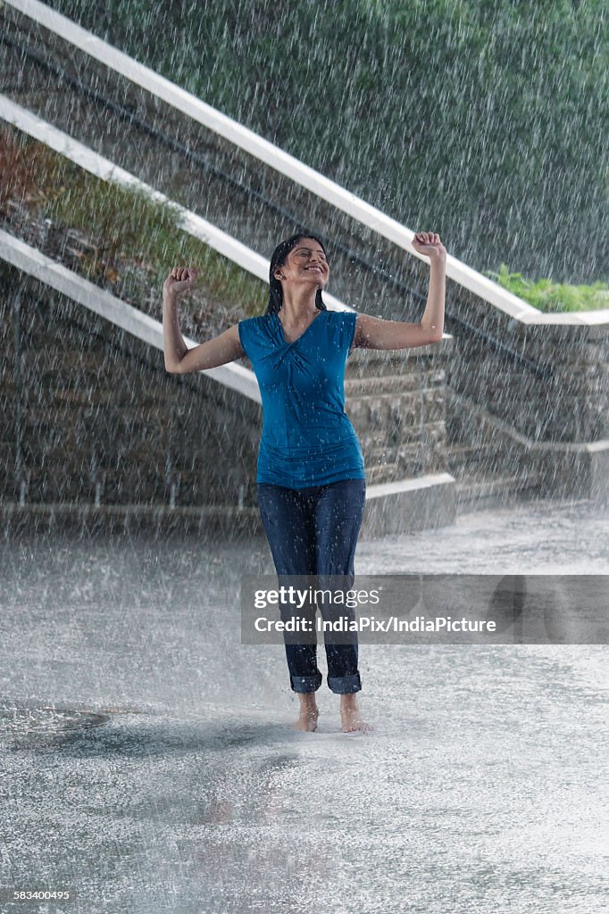 Woman enjoying in the rain