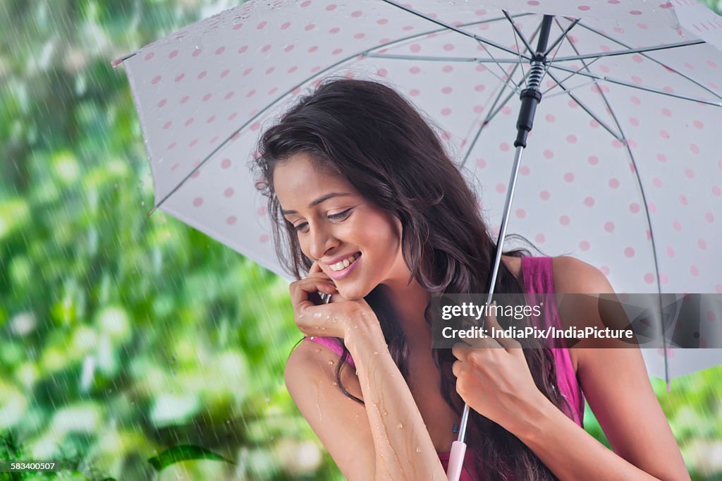 Woman with umbrella enjoying the rain