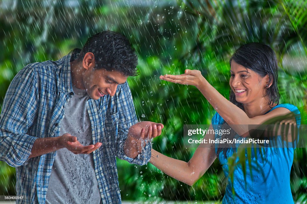 Couple having fun in the rain