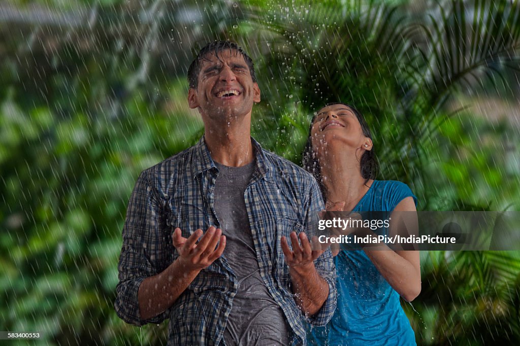 Couple enjoying in the rain