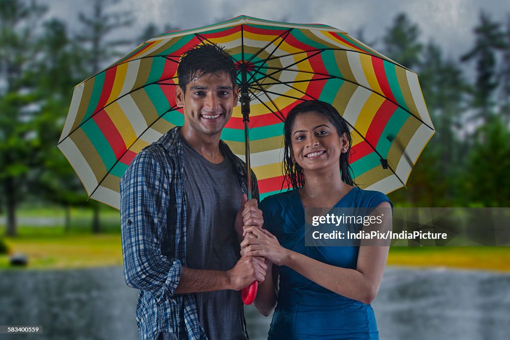 Portrait of couple with umbrella
