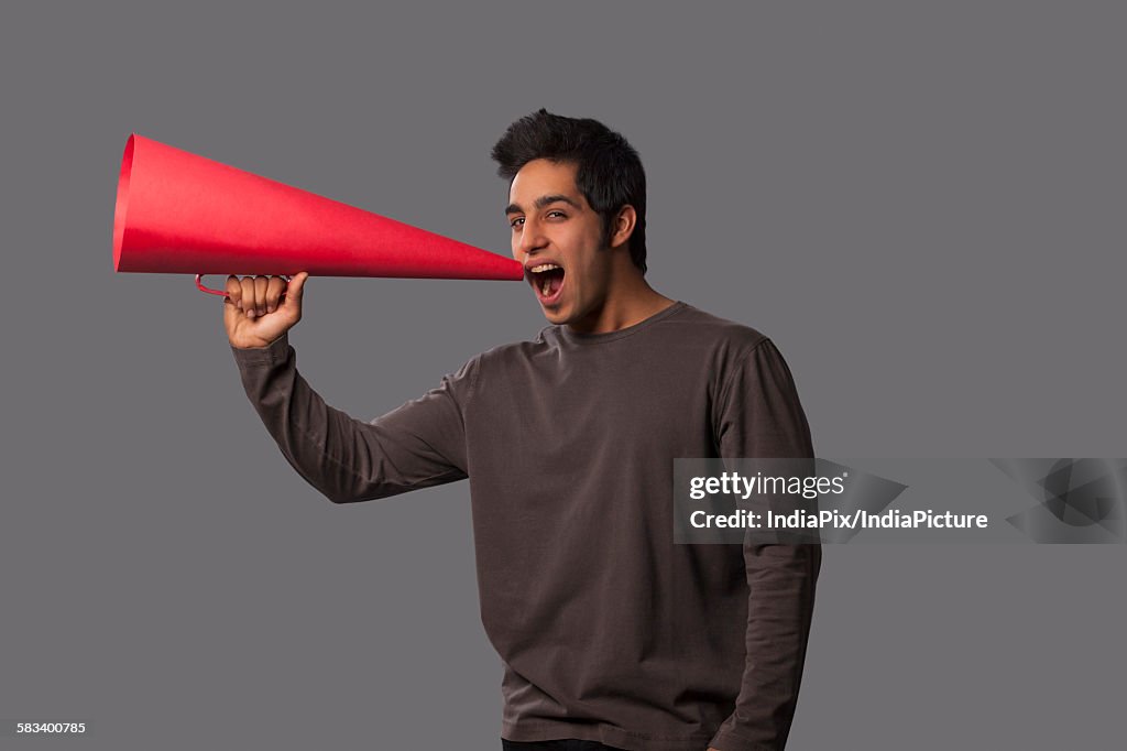 Portrait of young man with megaphone