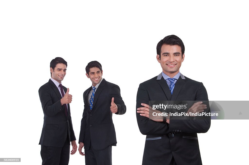 Colleagues giving thumbs up to fellow businessman