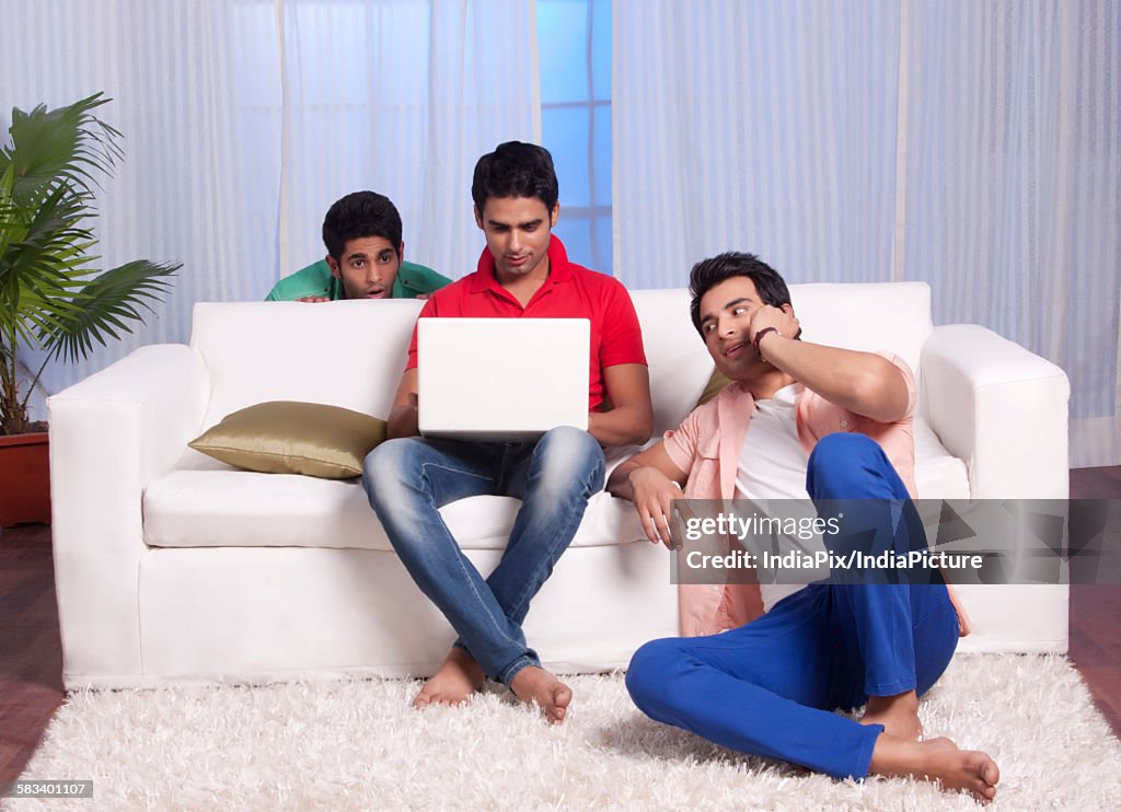 Man peeping into his friends laptop