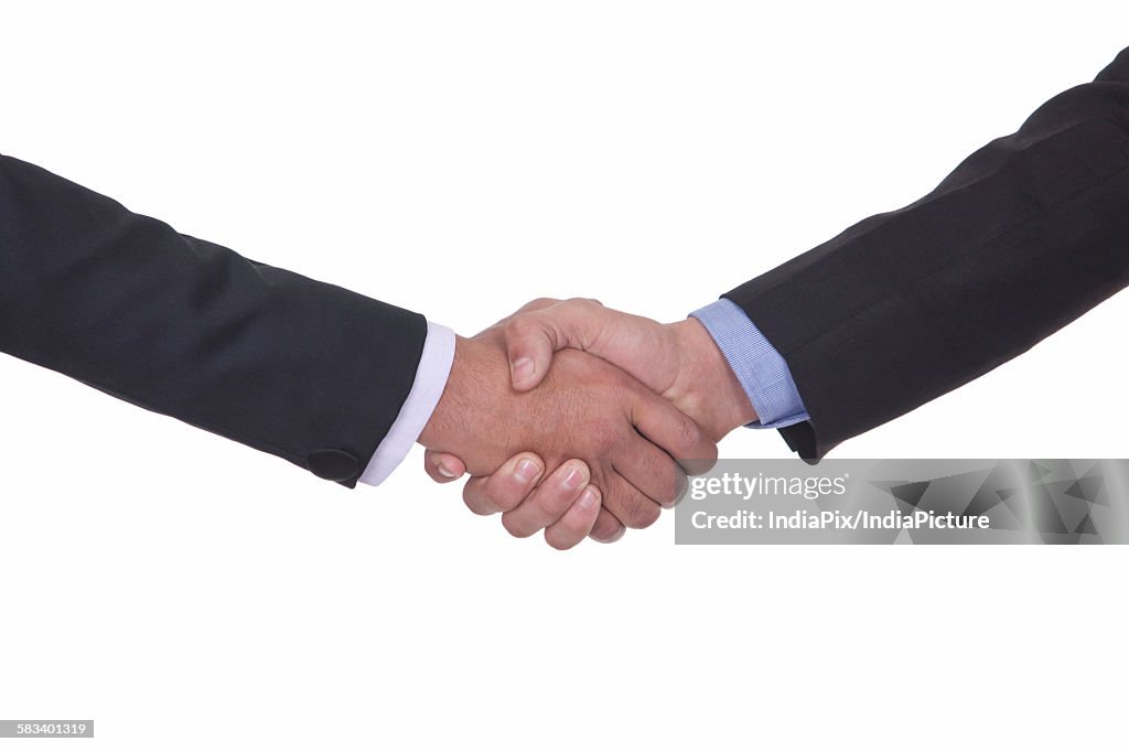 Close-up of two men shaking hands