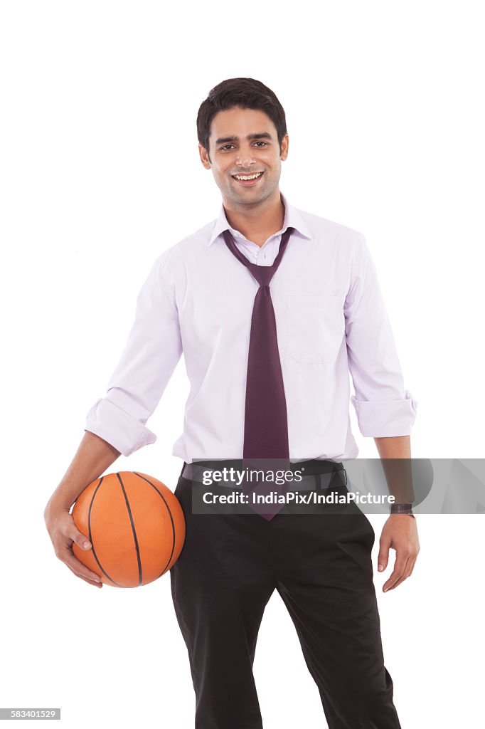 Portrait of a male executive with a basketball