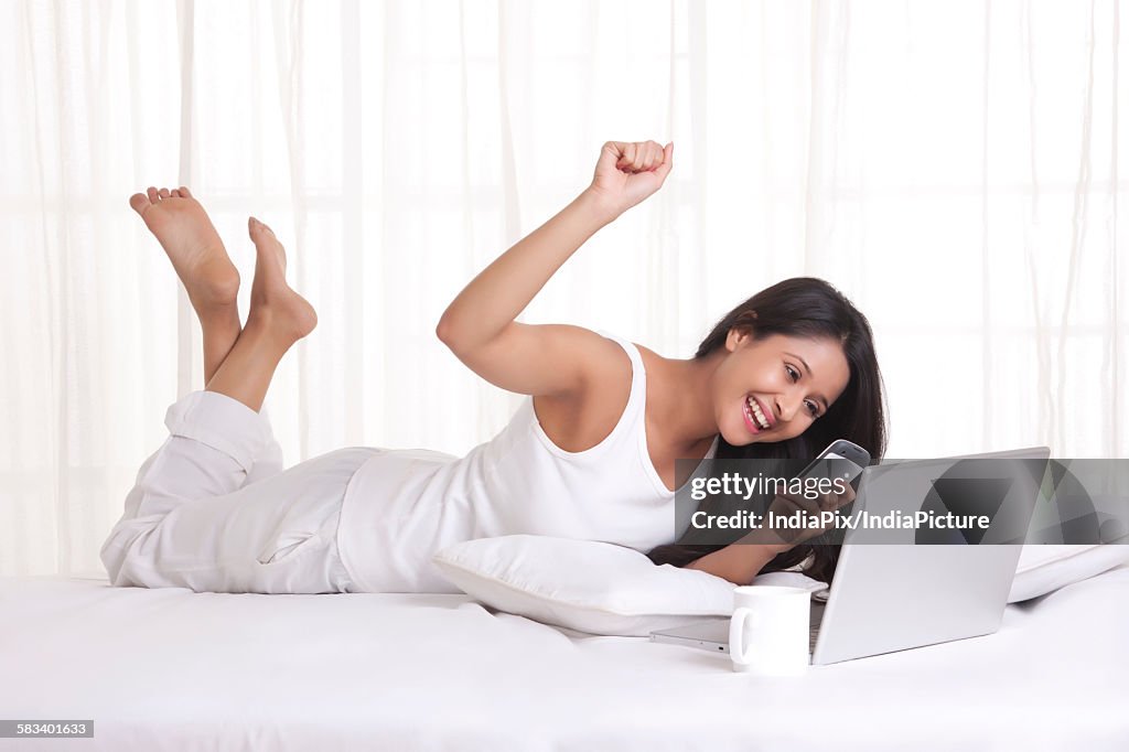 Young WOMEN with her cell phone and laptop