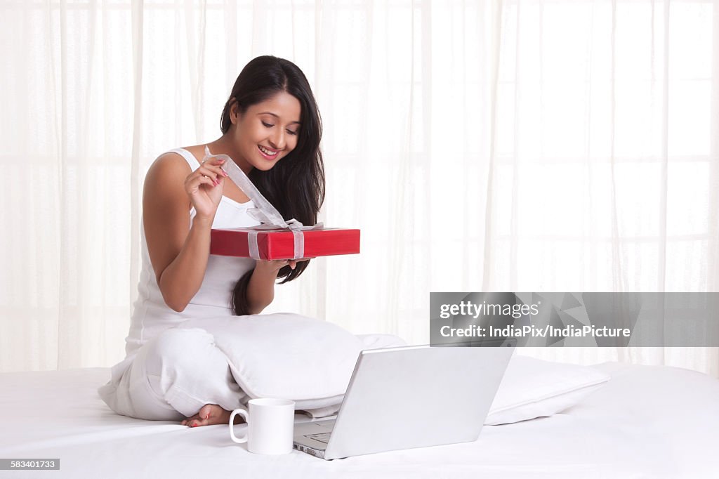 Young WOMEN opening a present