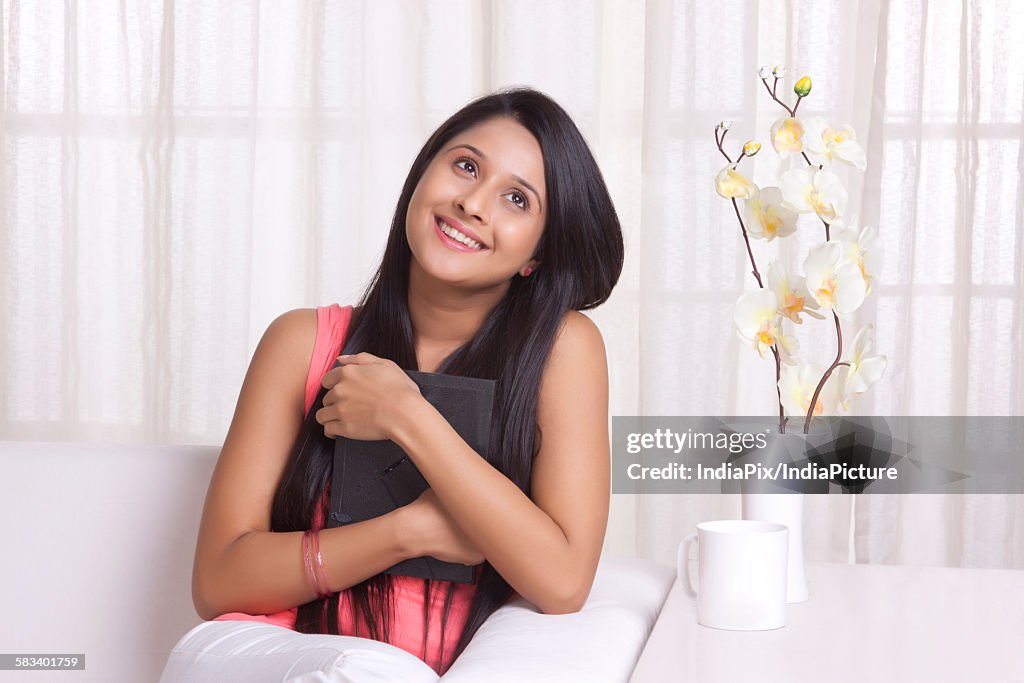 Young WOMEN hugging a photo frame