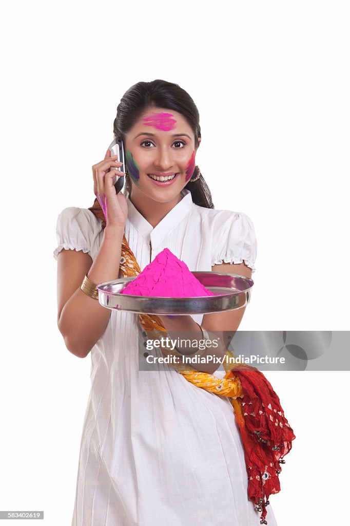 Portrait of a WOMEN with holi colour talking on a mobile phone