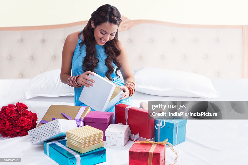 Woman opening gifts on valentines day