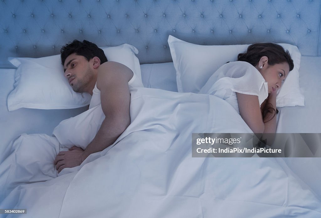 Angry couple in bed