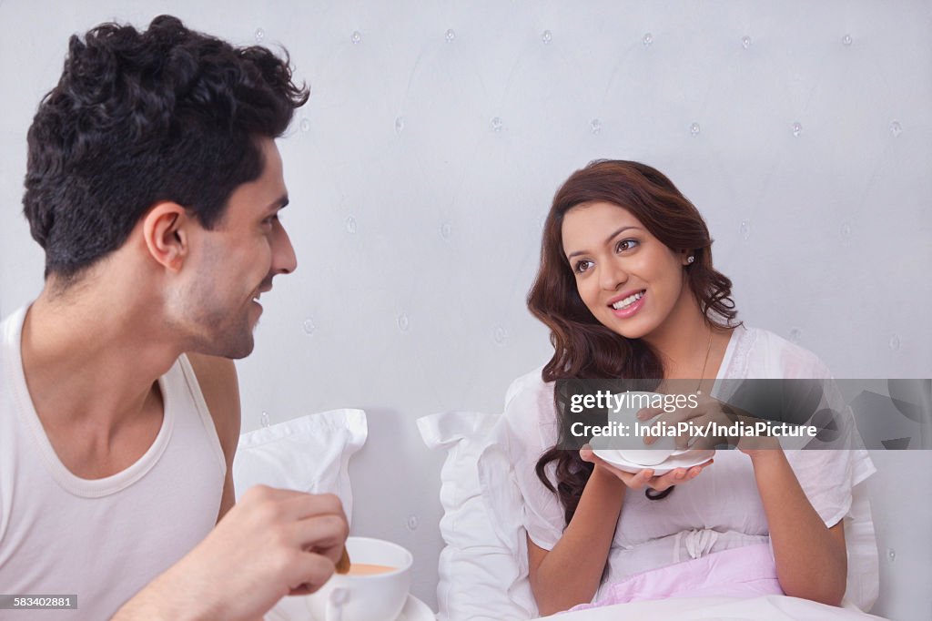 Couple having coffee in bed