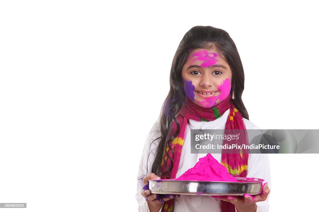 Portrait of a girl with a thali of holi colour