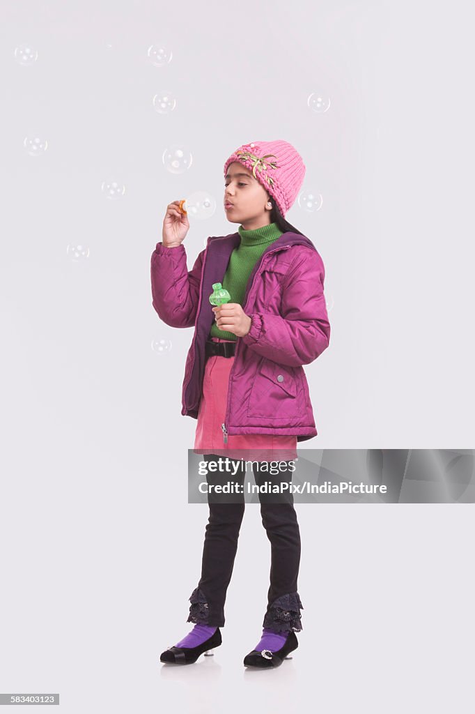 Girl blowing bubbles