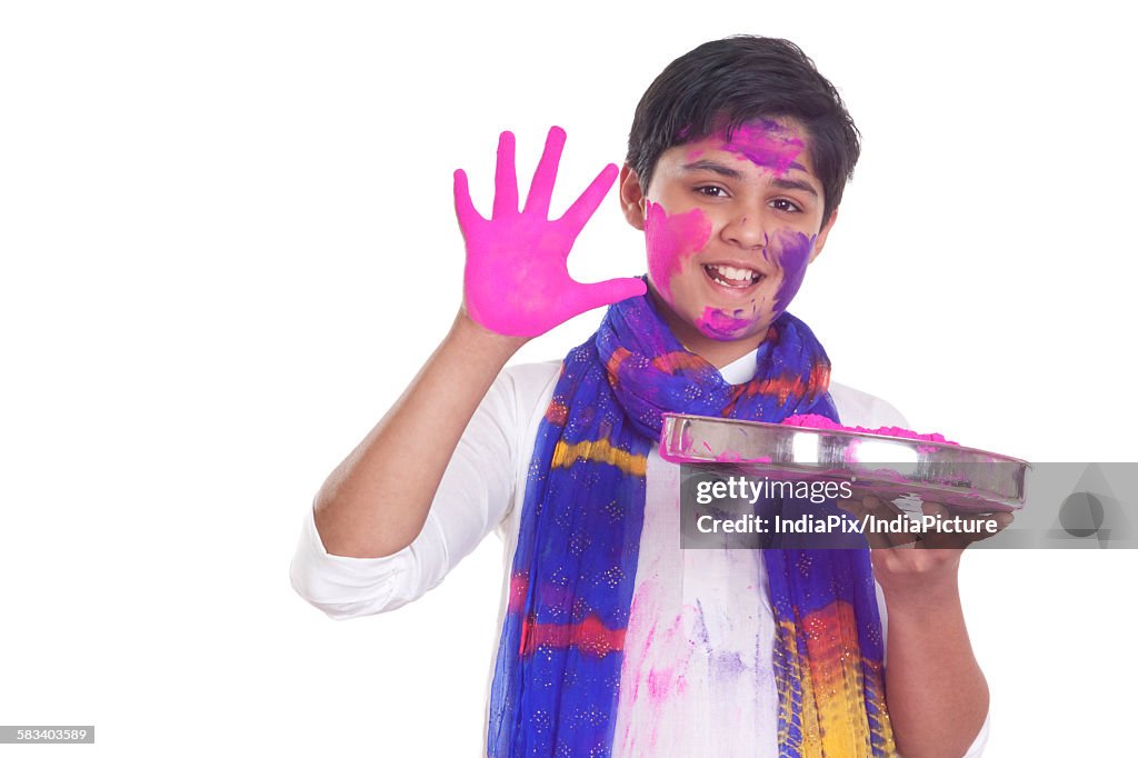 Portrait of a boy with a thali of holi colour