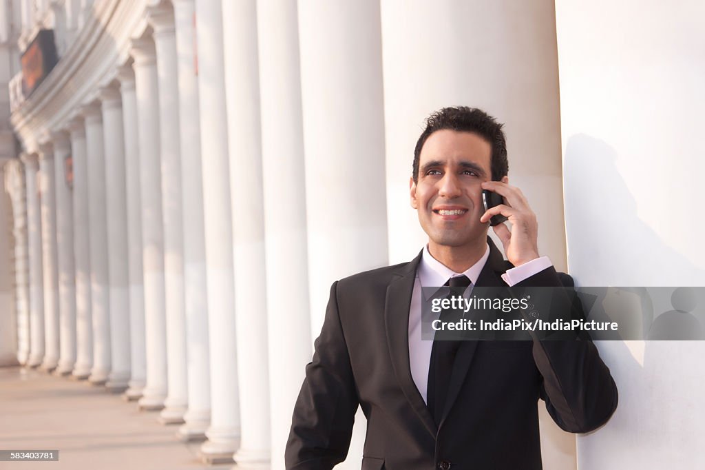 Businessman talking on a mobile phone  , INDIA , DELHI