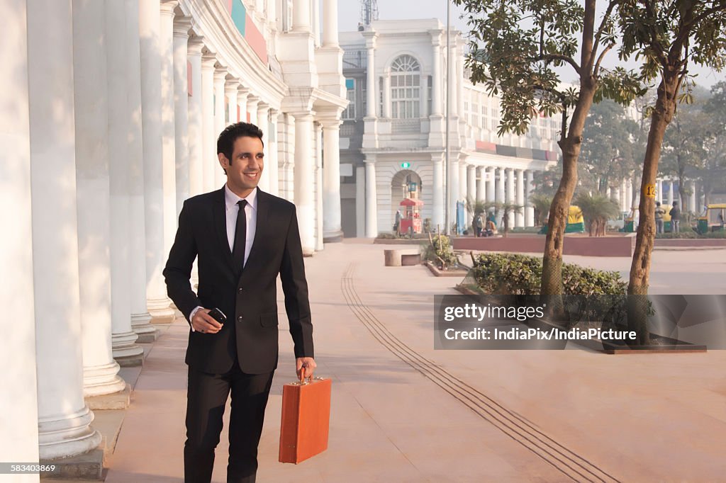 Businessman with suitcase and mobile phone , INDIA , DELHI