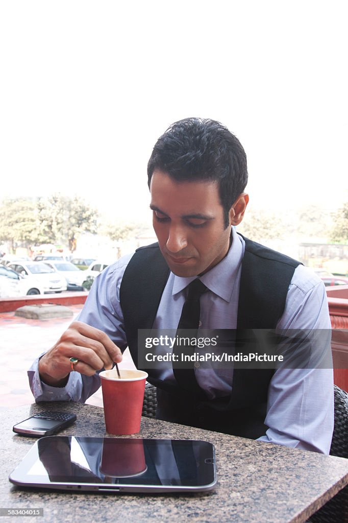 Businessman having coffee , INDIA , DELHI