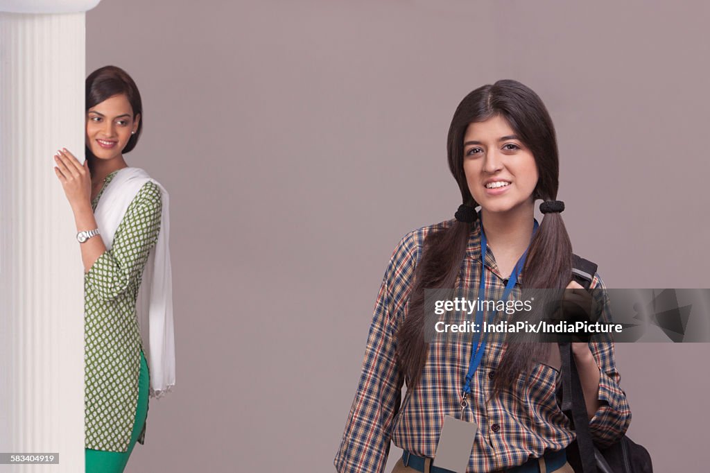 Elder sister watching younger sister leave for school