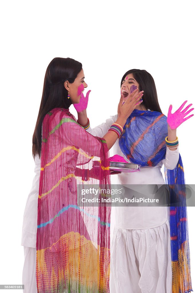 Young women playing holi