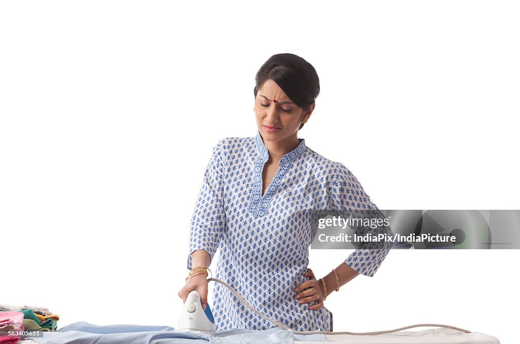 Young woman ironing