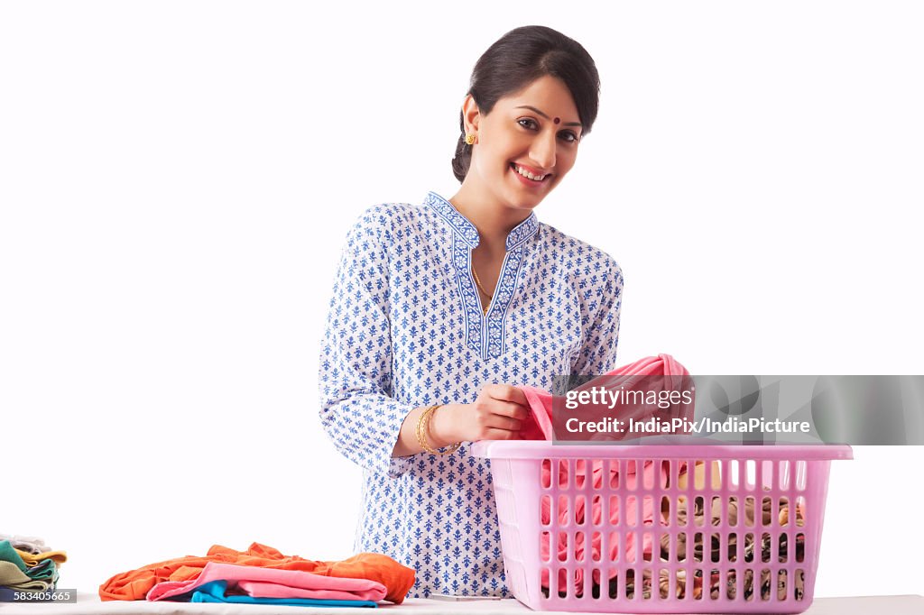 Young woman sorting out clothes