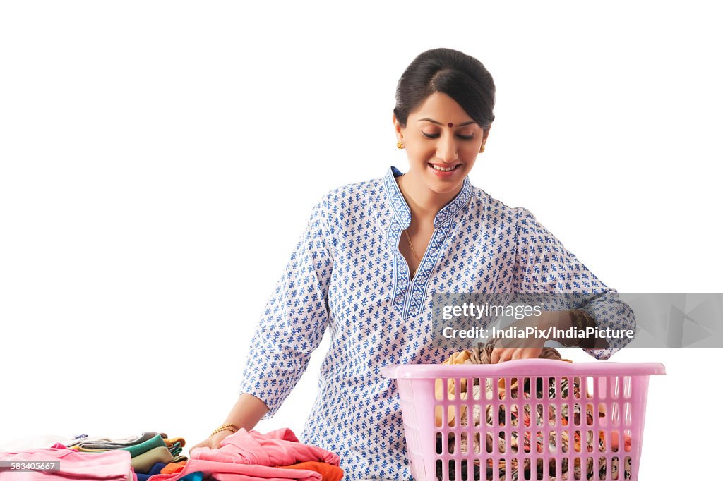 Young woman sorting out clothes