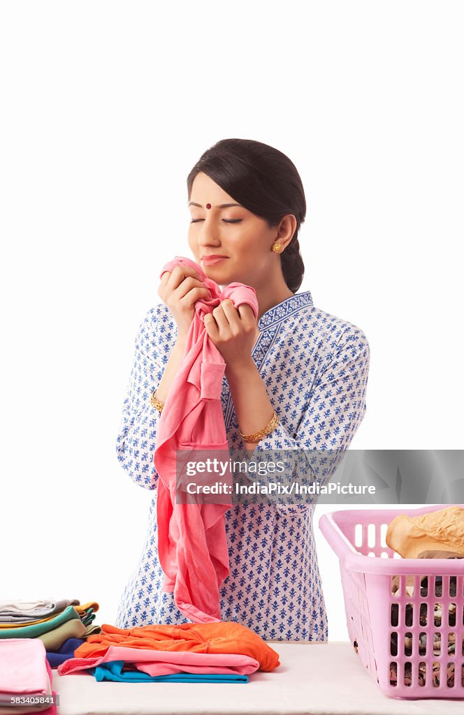 Young woman sorting out clothes