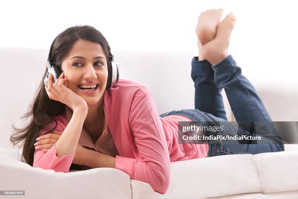 Young woman listening to music on her headphones