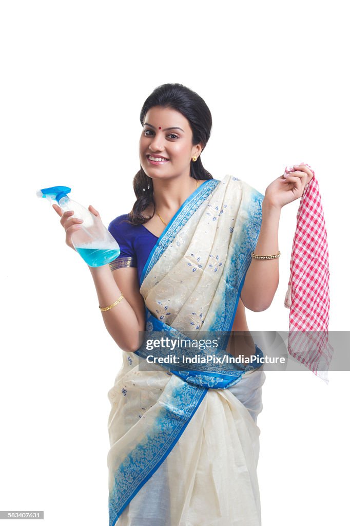 Portrait of housewife with spray bottle and cloth