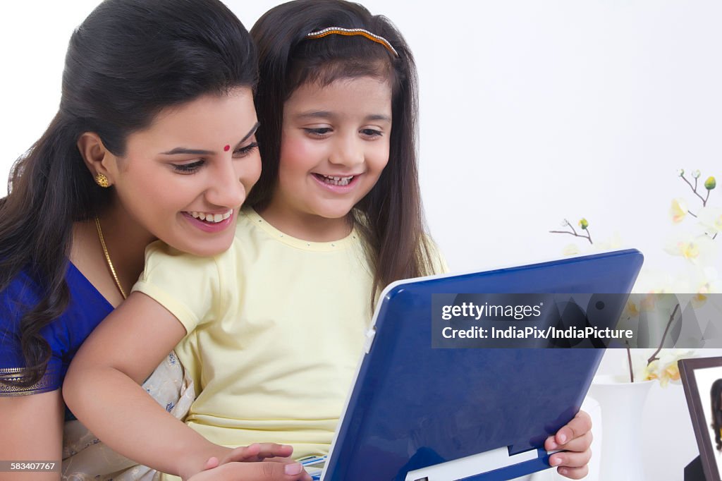 Mother and daughter with a computer