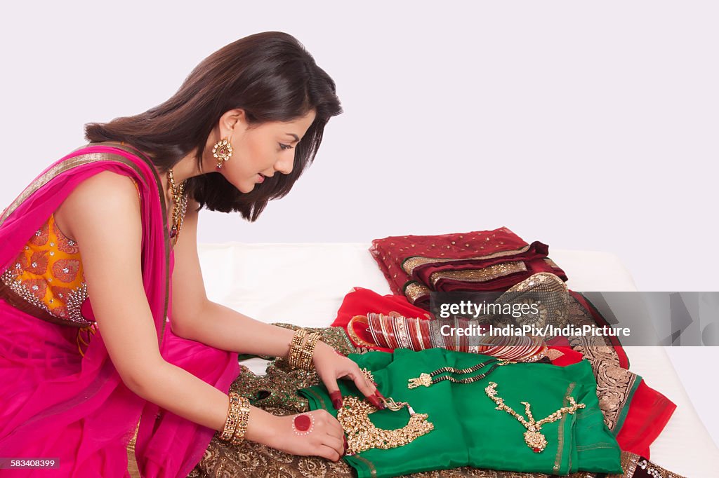 Woman looking at jewelery and wedding attire