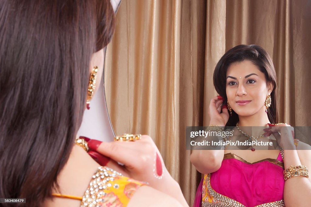 Beautiful woman admiring her jewelery