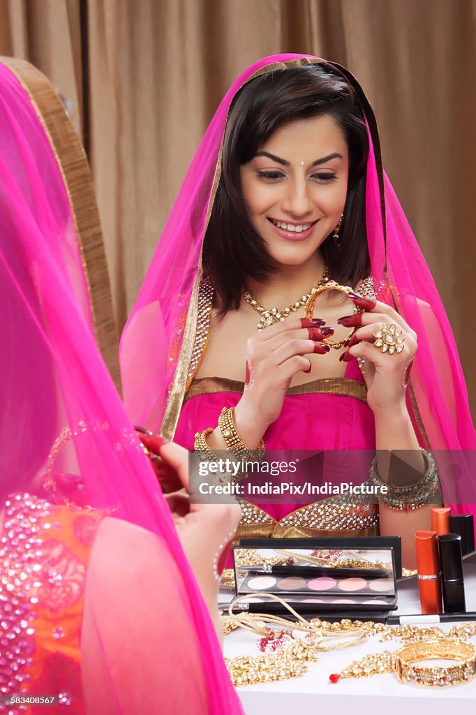 Beautiful woman looking at a bangle